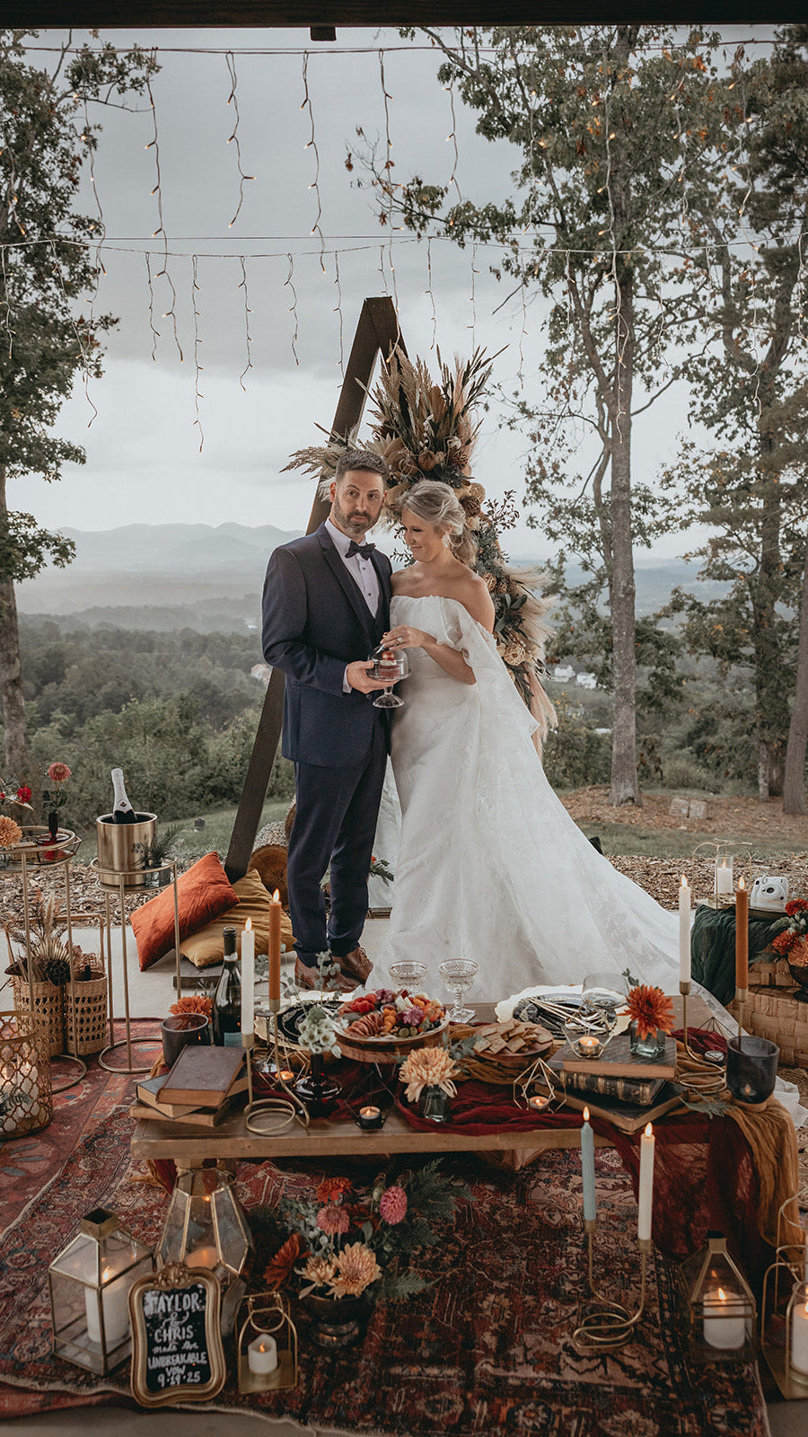 Couple at a wedding reception with a scenic background of trees and mountains.  asheville luxury picnics. pop-up picnic. picnic pop-up avl