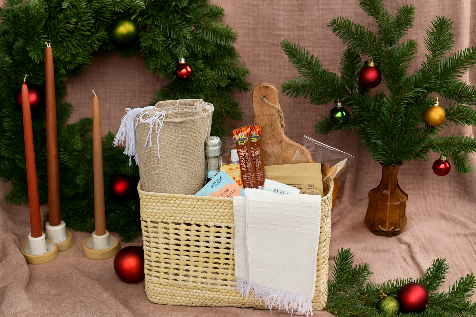 Luxury picnic basket backpack with items on a tablecloth with Christmas decorations